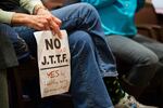 A protester holds a sign opposed to Portland's involvement in the FBI-led Joint Terrorism Task Force at a City Council meeting Wednesday, Feb. 13, 2019, in Portland, Ore. The council voted to leave the JTTF.