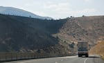 A stark line between burned and unburned land on the hills surrounding I-84 east near Durkee, Ore., July 31, 2024. The Durkee fire was started by a lightning strike in mid-July and burned nearly 295,000 acres of grassland over the course of two weeks.