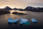 FILE - In this Aug. 16, 2019, photo, large Icebergs float away as the sun rises near Kulusuk, Greenland.
