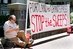 FILE: Jeff Liddicoat doesn’t like the term homeless — “I live outside,” he says, while attending an event held in at Pioneer Courthouse in Portland, Ore., April 22, 2024, organized by Stop The Sweeps PDX. 