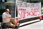 FILE: Jeff Liddicoat doesn’t like the term homeless — “I live outside,” he says, while attending an event held in at Pioneer Courthouse in Portland, Ore., April 22, 2024, organized by Stop The Sweeps PDX.