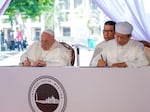 Pope Francis and the Grand Imam Nasaruddin Umar (right) sign the "Joint Declaration of Istiqlal 2024" as they meet at the Istiqlal Mosque in Jakarta, Thursday. Pope Francis urged Indonesia to live up to its promise of "harmony in diversity" and fight religious intolerance as he set a rigorous pace for an 11-day, four-nation trip through tropical Southeast Asia and Oceania.