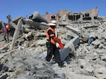 Palestinian rescuers search the rubble of destroyed buildings in Rafah, in the southern Gaza Strip, on Thursday.