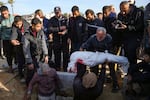 Palestinians bury the body of a relative who was killed in the Israeli bombardment of the Gaza Strip, Tuesday, Jan. 14, 2025.