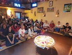 In this photo provided by Ganga Sharma, people gathered on Aug. 30, 2026, for a vigil at the Nirtya Mandala Mahavihara Buddhist temple in Portland, honoring flood victims in Nepal.