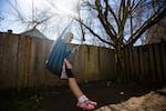 Jennifer, 12, swings from a tree in the backyard of her family's home in Hillsboro, Ore., Friday, March 1, 2019.