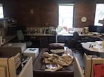 A cot, squeezed in among office cubicles at a child abuse hotline office, where a teen slept back in June 2016.