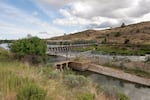 FILE: The Klamath River head gates are seen here on Wednesday, June 9, 2021 in Klamath Falls, Ore. The U.S Bureau of Reclamation has reduced water available for farmers in the region, leading to concerns about crops drying up.