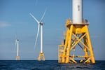 FILE - Three of Deepwater Wind's five turbines stand in the water off Block Island, R.I., Aug. 15, 2016.