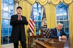 Elon Musk takes questions from reporters as President Trump looks on in the Oval Office of the White House on Tuesday.