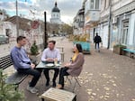 From left: Ivan Sushchyk, Vadym Zahozytsky and Yana Yelizarova discuss U.S. support for the war in Ukraine at a coffee shop in Kyiv on Oct. 11.