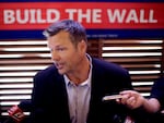 Former Kansas Secretary of State Kris Kobach talks to the media after announcing his Senate candidacy on July 8, 2019.