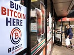 A 'Buy Bitcoin Here' sign is posted at a 7-Eleven store in Los Angeles on Nov. 10, 2021. How much the halving contributes to gains in bitcoin has been a subject of continued debate.