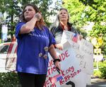 Ryan Olski, left, protests outside Vancouver City Hall against a proposed ordinance to ban "targeted picketing,” on June 6, 2022. Vancouver City Council unanimously passed the ordinance that evening.