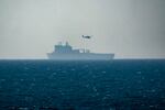 A ship is seen off the coast of Gaza near a U.S.-built floating pier, not seen, that is used to facilitate aid deliveries, as seen from the central Gaza Strip, Wednesday, July 10, 2024.