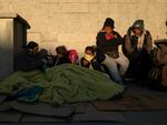 Migrants wake up after spending the night outside the immigration detention center in Ciudad Juarez, Mexico, where at least 40 people died, on March 29.