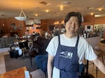 Owner Sean Dokko poses inside Butter Notes Cafe, a dessert cafe and jazz club.