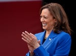 Democratic presidential nominee Vice President Kamala Harris greets members of the Aliquippa High School football team during a campaign stop at their school, Sunday, Aug. 18, 2024, in Aliquippa, Pa.