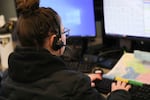 In this undated photo provided by Portland's Bureau of Emergency Communication, a 9-1-1 call dispatcher is pictured at work.