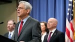 Attorney General Merrick Garland speaks with reporters during a news conference at the Department of Justice on Wednesday as Secretary of Homeland Security Alejandro Mayorkas, right, looks on.