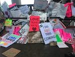 Rain-soaked signs pile up near a public trashcan after the Women's March on Portland, Saturday, Jan. 21, 2017.