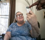 Penny Harmon learns how to use the remote to her new air conditioning unit courtesy of Portland Clean Energy Fund in Portland, Ore., July 1, 2025. PCEF's Cooling Portland program provides portable cooling equipment to low-income city residents, prioritizing those who need it most. 