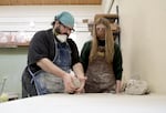 Ceramics tutor Arthur Malliet helps out a student during a class run by teacher John Hasegawa at Mt. Hood Community College.