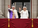 Britain's King Charles III wearing the Imperial state Crown, and Britain's Queen Camilla wearing a modified version of Queen Mary's Crown wave from the Buckingham Palace balcony after viewing the Royal Air Force fly-past in central London on Saturday.