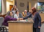 Brenda Meade, right, chair of the Coquille Tribal Council, shakes hands with members of the Oregon Fish and Wildlife Commission on June 17 after the commission approved a co-management agreement between the tribe and state.