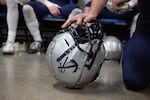 A Lake Oswego player leans on his helmet during halftime of the Oregon 6A football championship at Hillsboro Stadium in Hillsboro, Ore., Saturday, Dec. 7, 2019. Central Catholic defeated Lake Oswego 49-28.
