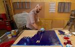 Artist Ben Buswell works on his latest piece