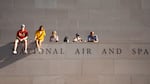 Fans look on from the National Air and Space Museum near the fan zone ahead of the Freedom 250 Grand Prix auto race.