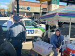 Police arrest an alleged thief, not shown, on Roosevelt Avenue in Queens, New York. The neighborhood has seen a jump in robbery over the past year. Many residents blame migrants, but this suspect was American.