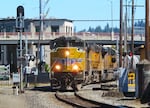 A Union Pacific train passes through the High Street crossing on May 30, 2025. As required by law, this train and all others must sound their horns at designated crossings to alert traffic and pedestrians to their presence.