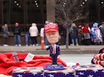 Merchandise is displayed for sale as guests wait in line to hear former President Donald Trump deliver a campaign speech in Iowa earlier this month.