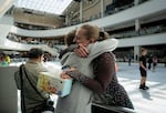 Stephanie Winningham, right, hugs Jenny Gilmore Robinson on the last open day of the Lloyd Center in Portland, Ore., on Aug 8, 2026. Both are part of a tight-knit skating community that lobbied to try and save it.