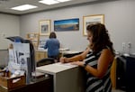 Debbie Taylor, the executive director of the Madras-Jefferson Chamber of Commerce, signs checks on Aug. 25, 2026 at the chamber’s office in Madras, Ore.  