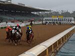 Horses run in the fourth race at Santa Anita Park in front of empty stands in Arcadia, Calif., in 2020.