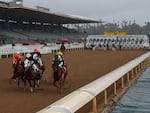 Horses run in the fourth race at Santa Anita Park in front of empty stands in Arcadia, Calif., in 2020.