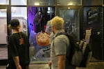 Demonstrators walk past a destroyed eatery in Portland, Ore., on May 29, 2020. A smaller group of protesters took to the streets following hours of peaceful demonstration to memorialize George Floyd.