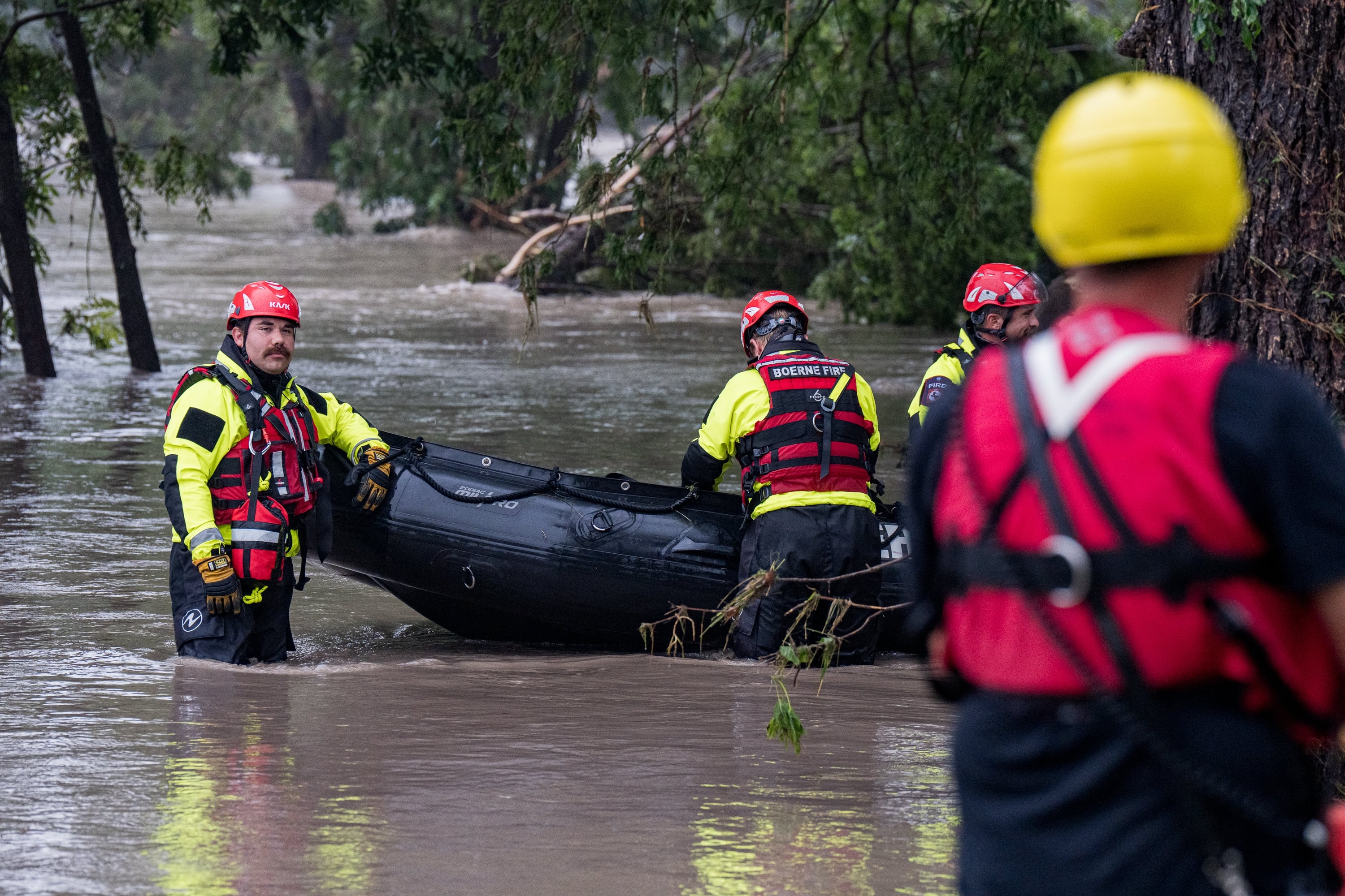 Search and rescue team members prepare their boat for operations on the flooded Guadalupe River on Friday in Comfort, Texas. The ferocity and sheer destruction of the flash flood caught officials off-guard.
