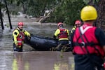 Search and rescue team members prepare their boat for operations on the flooded Guadalupe River on Friday in Comfort, Texas. The ferocity and sheer destruction of the flash flood caught officials off-guard.