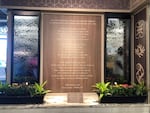 A water wall inside the newly reopened Tops grocery store pays tribute to the shooting victims with a poem by Buffalo's poet laureate, Jillian Hanesworth.