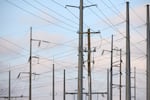 Transmission lines and electricity infrastructure adjacent to a construction site for an Amazon Web Services data center in Hilliard, Ohio. Because nuclear takes so long to develop, some critics fear that AI will be powered by natural gas for the foreseeable future.