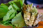 Wasabi rhyzome and leaves on a plate.