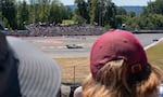 David Commeree, left, and Jerod Davis, right, watch the NTT Series IndyCars speed through turns one, two and three.