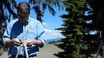 Chris Wayne adjusts a microphone stand. Scientists at Crater Lake National Park have recorded natural sound for a month at a time at 20 locations in the park. 