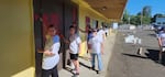 Volunteers paint a restaurant in downtown Sweet Home, Oregon