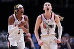 UConn guard Paige Bueckers (5) and UConn forward Aaliyah Edwards (3) react during the first half of the team's Sweet 16 college basketball game against Duke in the women's NCAA Tournament, Saturday, March 30, 2024, in Portland, Ore.