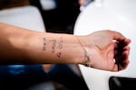 Michal Rahav and her husband tattooed "Until the last bullet," in Hebrew, on their arms following the Oct. 7 Hamas attack. Militants stormed their house, her husband shot one dead and handed her a rifle telling her to fight until the last bullet. She was relocated with her family to Eilat.